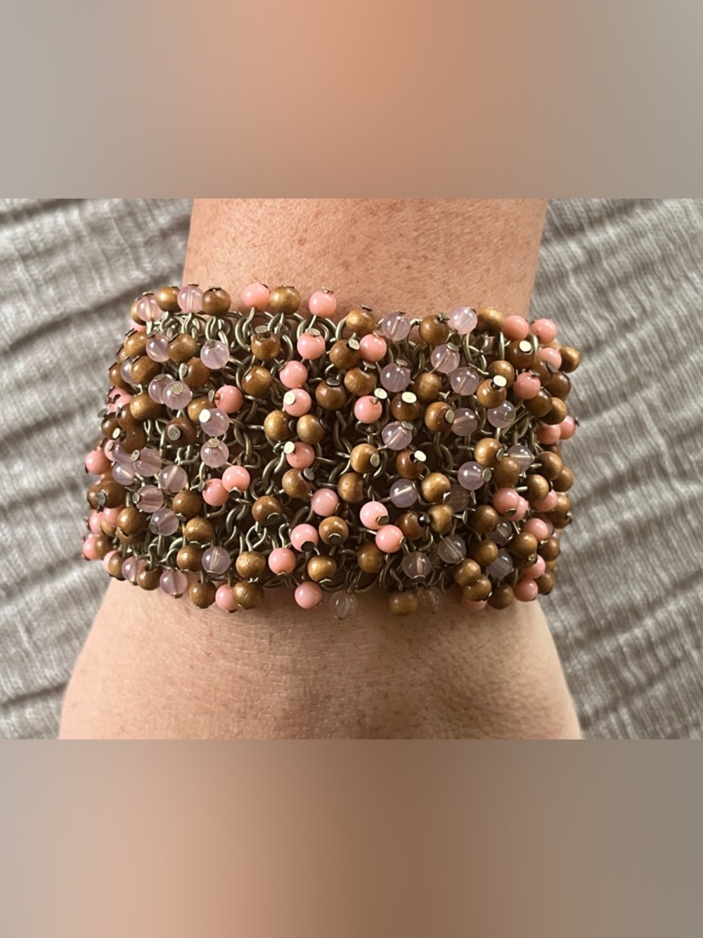 Vintage multi-strand bracelet with wood and glass beads on a metal chain.